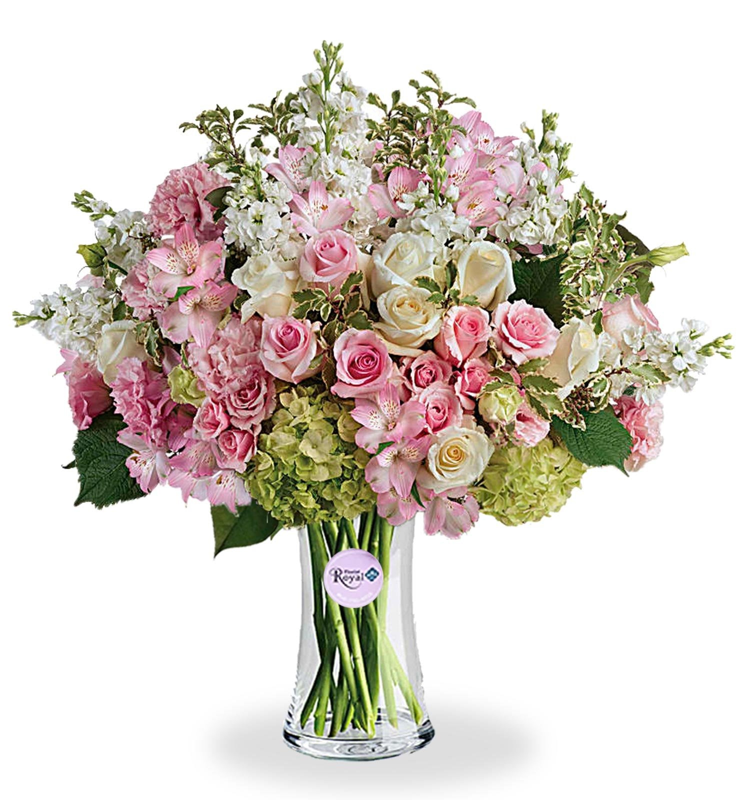 A floral arrangement featuring green hydrangea, pink roses, white roses, pink spray roses, light pink alstroemeria, pink lisianthus, and white stock in various shades of pink, green, and white tones, presented in a clear glass vase.