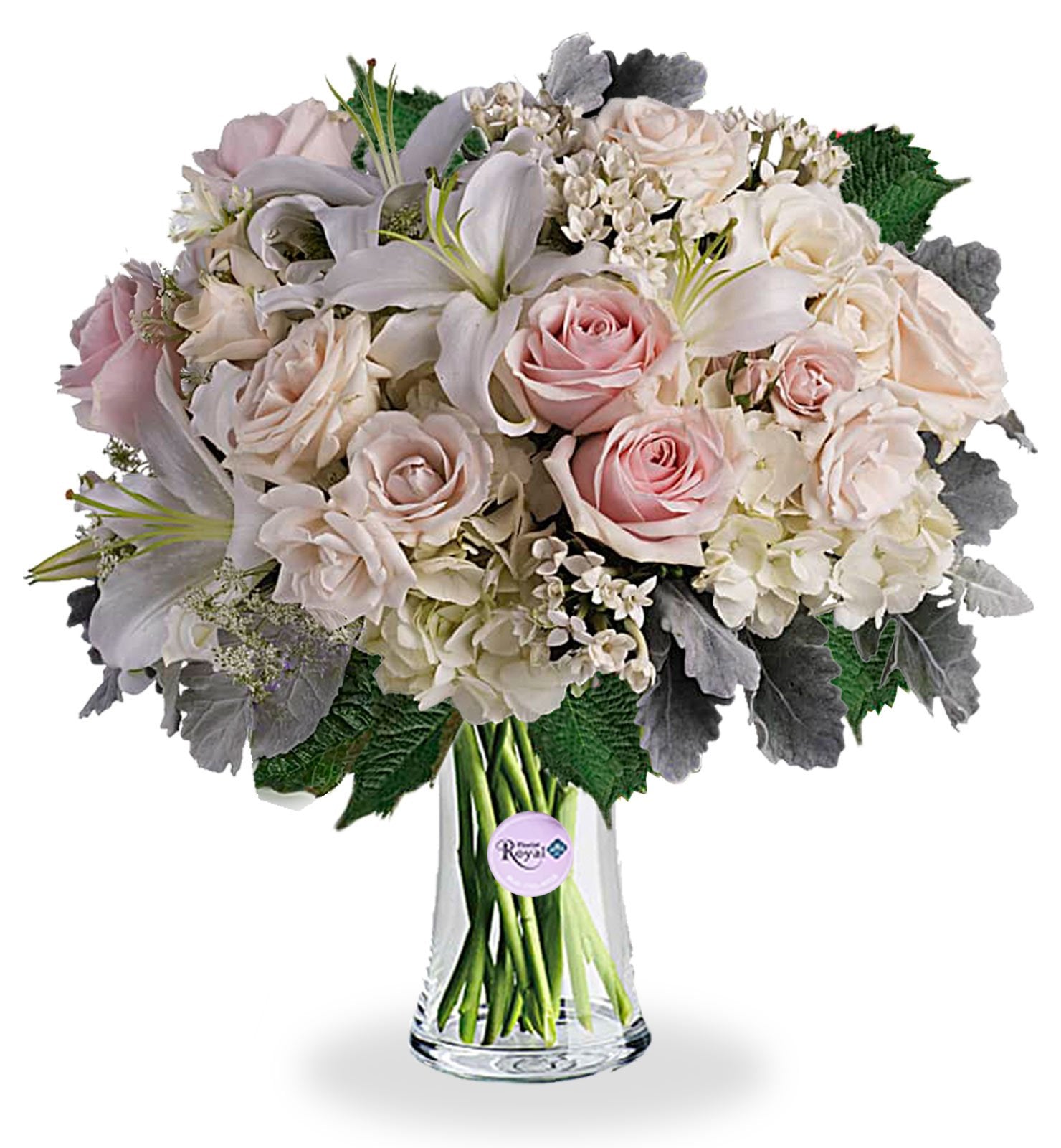 A bouquet of white, crème, and light pink roses with hydrangea and lilies in a clear vase.